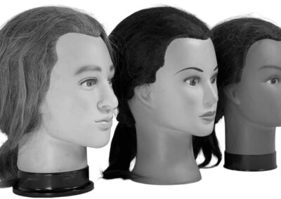 Three mannequin heads without hats, symbolizing the decline of everyday hat wearing in the 1960s.