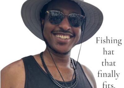Man wearing a gray boonie hat while smiling outdoors, chosen as a fishing hat that finally fits comfortably.