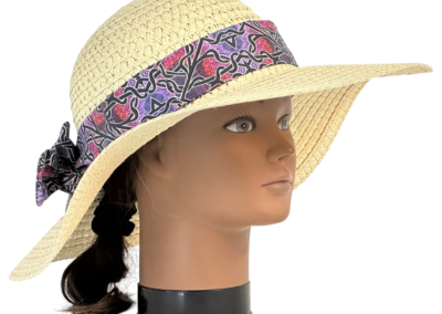 Folies line floppy hat band made with a curated artist-designed print, styled on a hat.