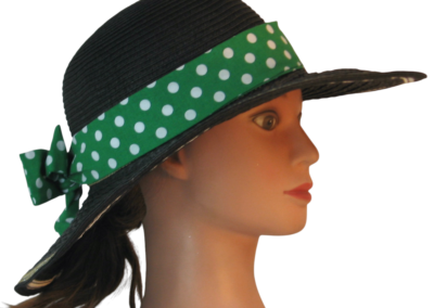 Floppy hat band with short fabric ties tied into a balanced bow on a wide-brim hat.