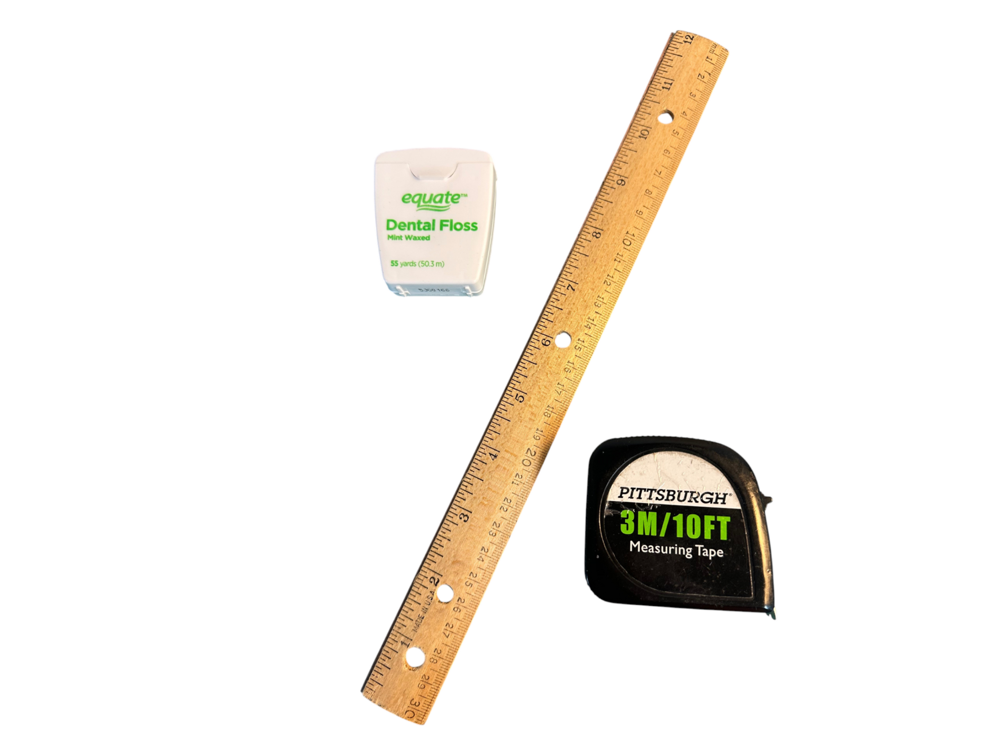 Tools used to measure your head size, including dental floss, a wooden ruler, and a retractable tape measure, on a white background.