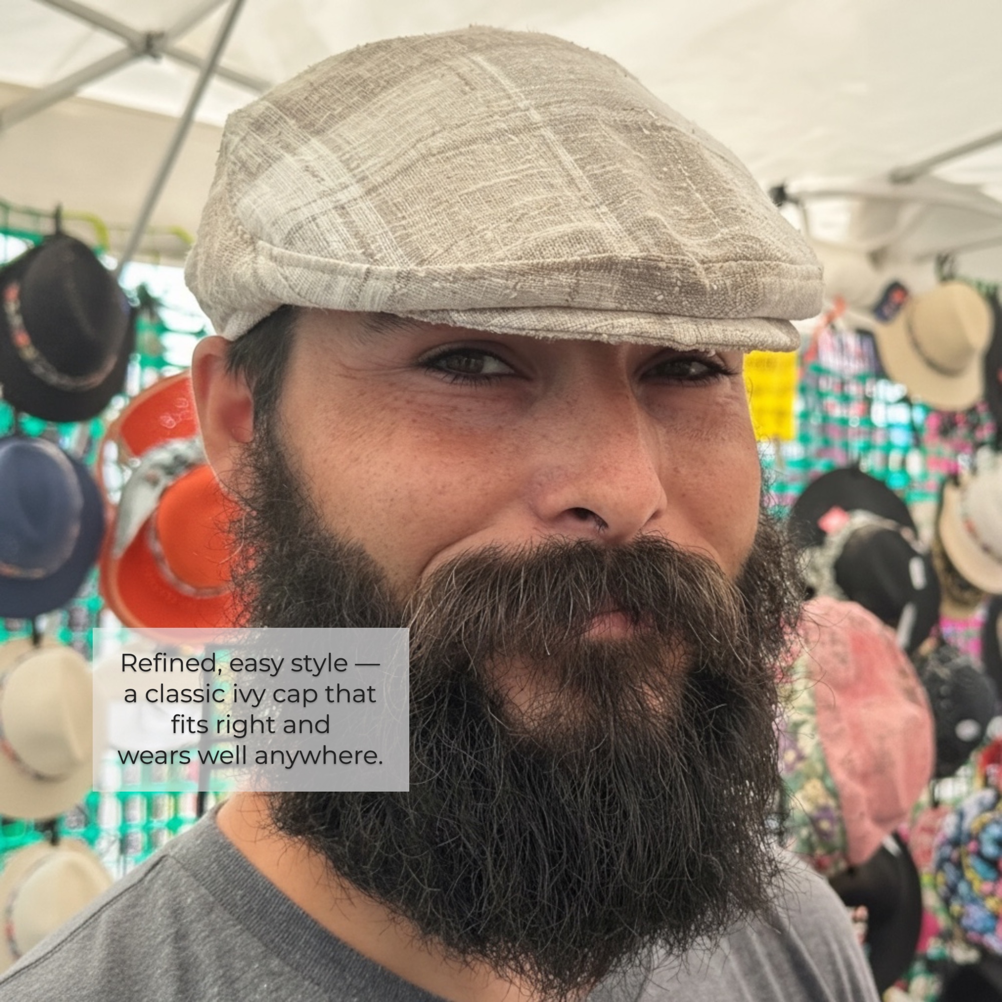 Man with beard wearing a cream plaid ivy flat cap showing classic style and texture