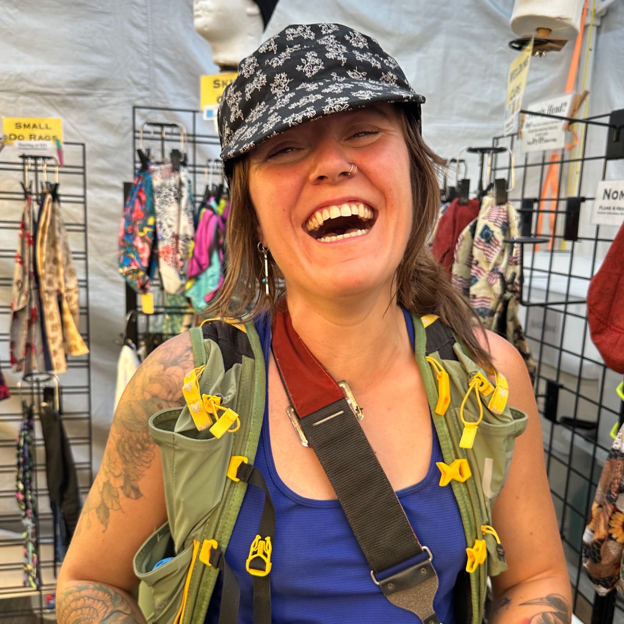 Floral Military Patrol Cap on Woman at Street Fair Woman wearing black floral military patrol cap at Tucson street fair