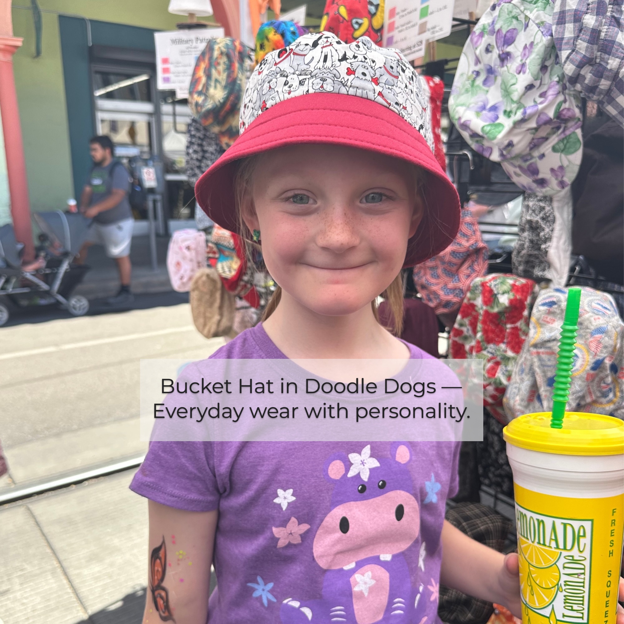 Bucket Hat – Everyday Wear at Street Fair Girl wearing a bucket hat while holding a drink at an outdoor street fair.